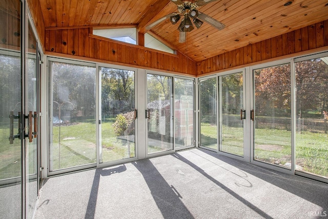 unfurnished sunroom featuring wood ceiling, a healthy amount of sunlight, and ceiling fan