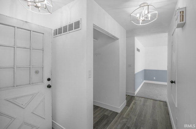 interior space featuring an inviting chandelier and dark wood-type flooring