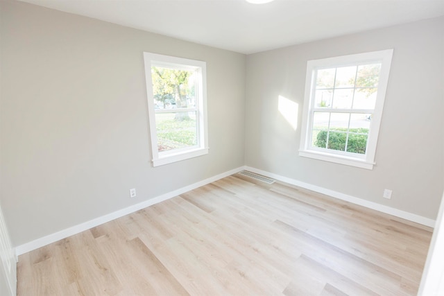 spare room with light hardwood / wood-style floors