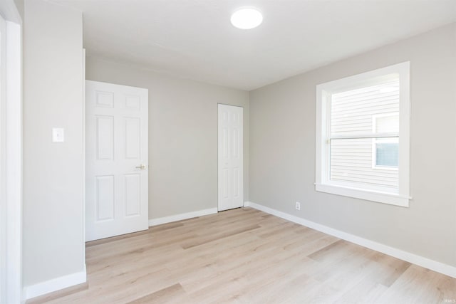 empty room with light hardwood / wood-style flooring