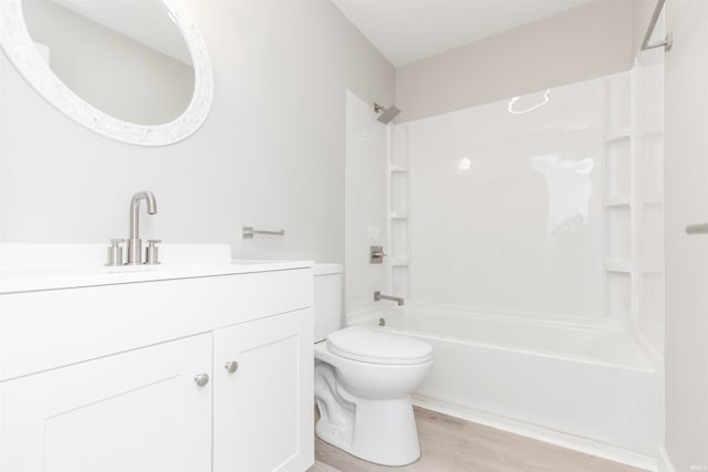 full bathroom with vanity, toilet, wood-type flooring, and bathing tub / shower combination