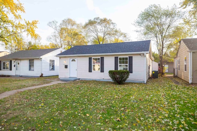 single story home with cooling unit and a front lawn