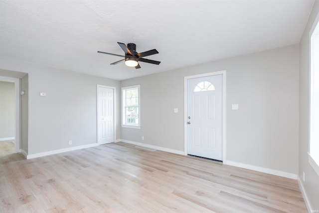 foyer with ceiling fan and light hardwood / wood-style flooring