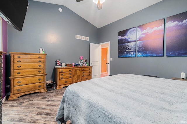 bedroom with dark hardwood / wood-style floors, vaulted ceiling, and ceiling fan