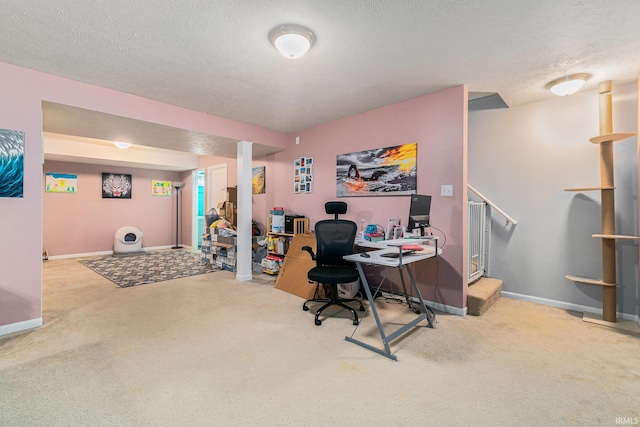 office area with carpet flooring and a textured ceiling