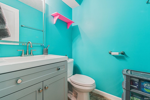 bathroom featuring vanity and toilet