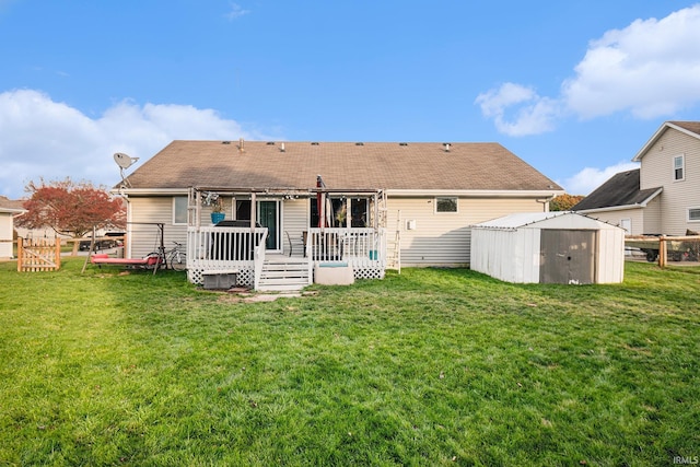 back of property with a lawn, a shed, and a deck