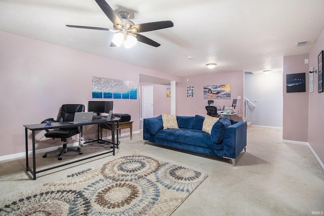 carpeted office space with ceiling fan