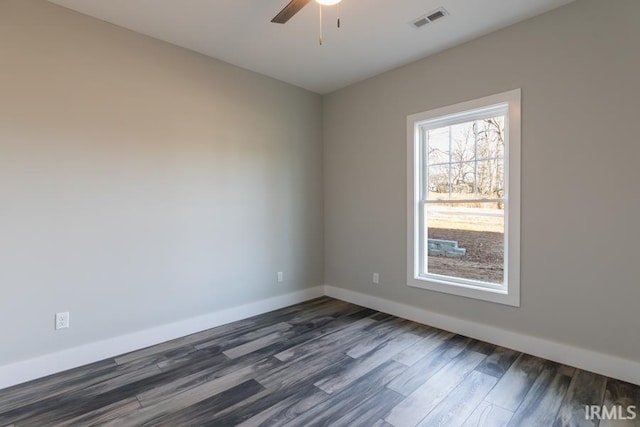 empty room featuring dark wood-type flooring and ceiling fan