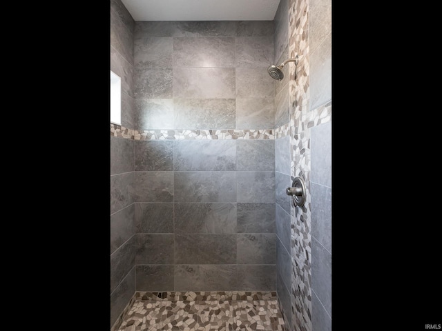 bathroom with a tile shower