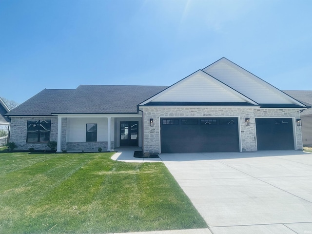4848 Abbeyville Dr, Lafayette, IN 47909 - view of front of house with a garage, concrete driveway, a front lawn, and stone siding