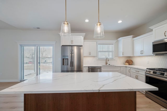 4848 Abbeyville Dr, Lafayette, IN 47909 - kitchen with stainless steel appliances, a sink, light wood-type flooring, backsplash, and recessed lighting
