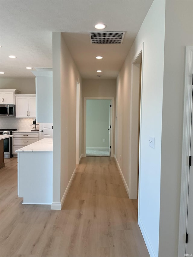 hallway featuring light wood-type flooring