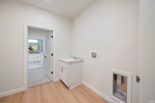 4848 Abbeyville Dr, Lafayette, IN 47909 - washroom featuring hookup for a washing machine, light wood-style flooring, baseboards, and cabinet space