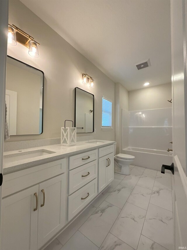 full bathroom with vanity, shower / tub combination, and toilet