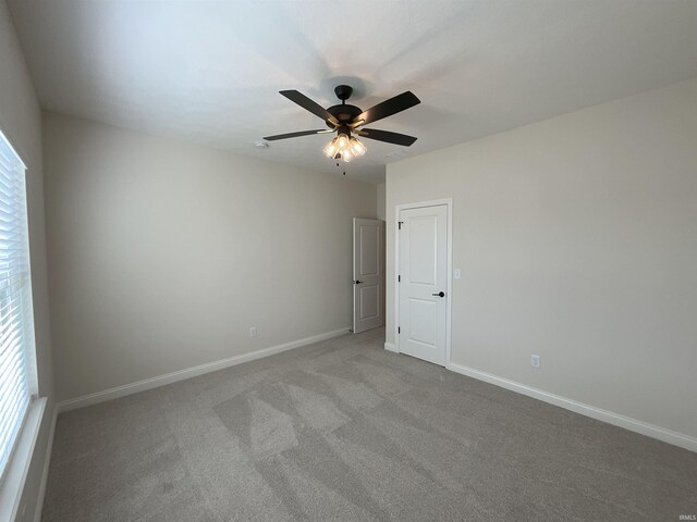 empty room with light carpet and ceiling fan