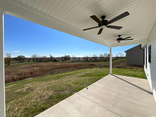 view of yard with ceiling fan and a patio