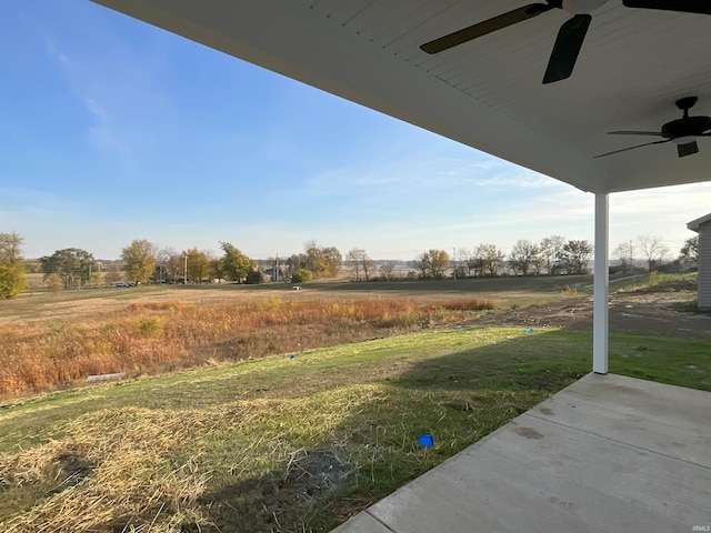 view of yard featuring ceiling fan and a patio