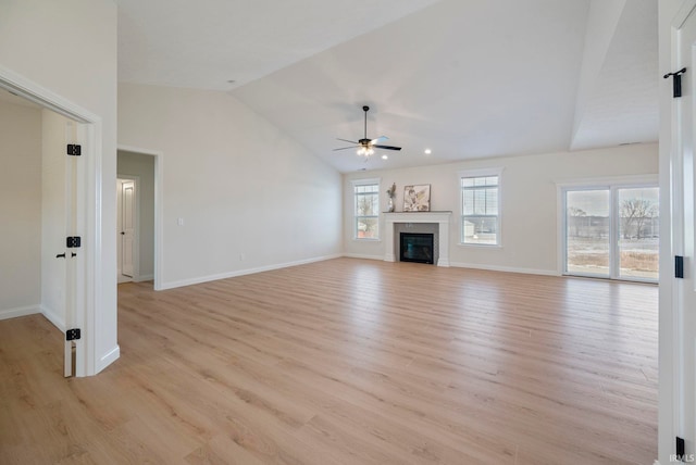4848 Abbeyville Dr, Lafayette, IN 47909 - unfurnished living room with a ceiling fan, vaulted ceiling, light wood finished floors, baseboards, and a glass covered fireplace