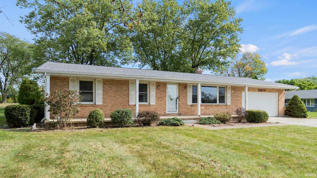 single story home featuring a front lawn and a garage