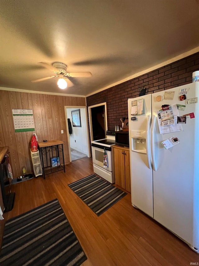 kitchen featuring ceiling fan, brick wall, light wood-type flooring, and white appliances