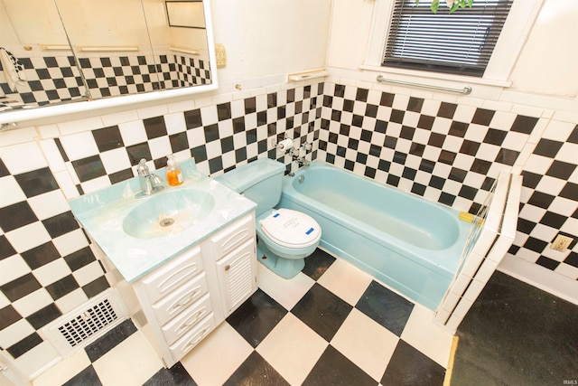 bathroom featuring vanity, a bathtub, and toilet