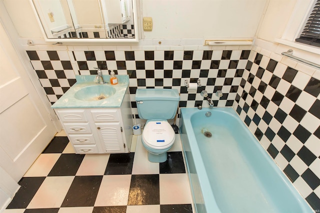 bathroom with toilet, tile walls, vanity, and a washtub