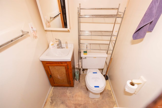 bathroom featuring vanity, toilet, and tile patterned flooring