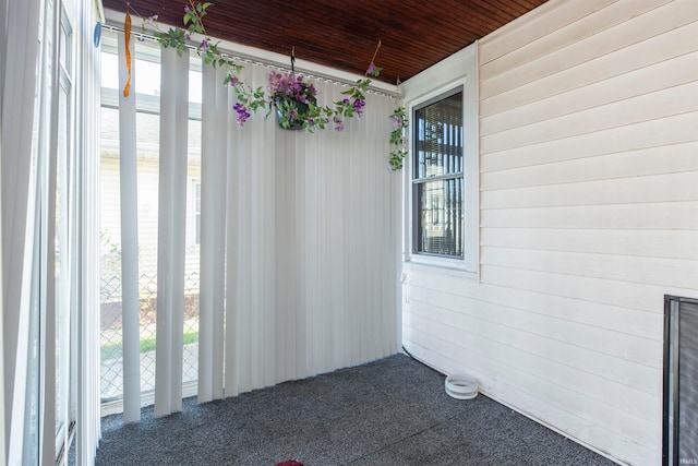 unfurnished sunroom with wooden ceiling