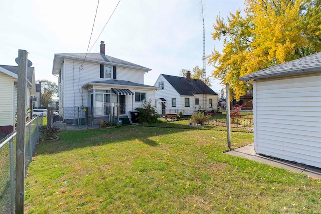 rear view of property featuring a yard