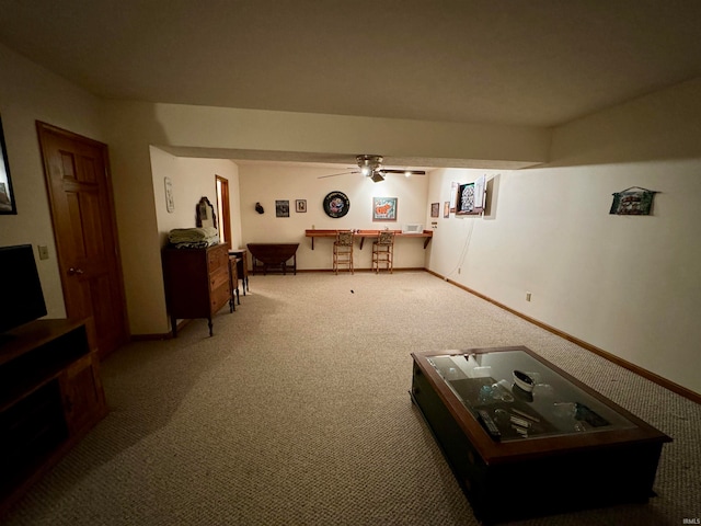 carpeted living room with ceiling fan