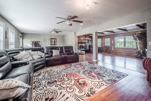 living room with a fireplace, hardwood / wood-style flooring, and ceiling fan