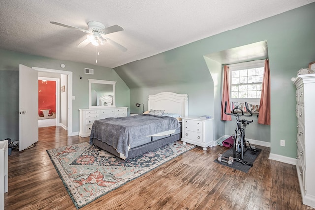 bedroom featuring a textured ceiling, vaulted ceiling, dark hardwood / wood-style floors, and ceiling fan