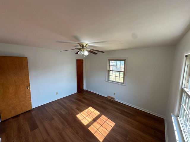 unfurnished room with ceiling fan and dark hardwood / wood-style floors