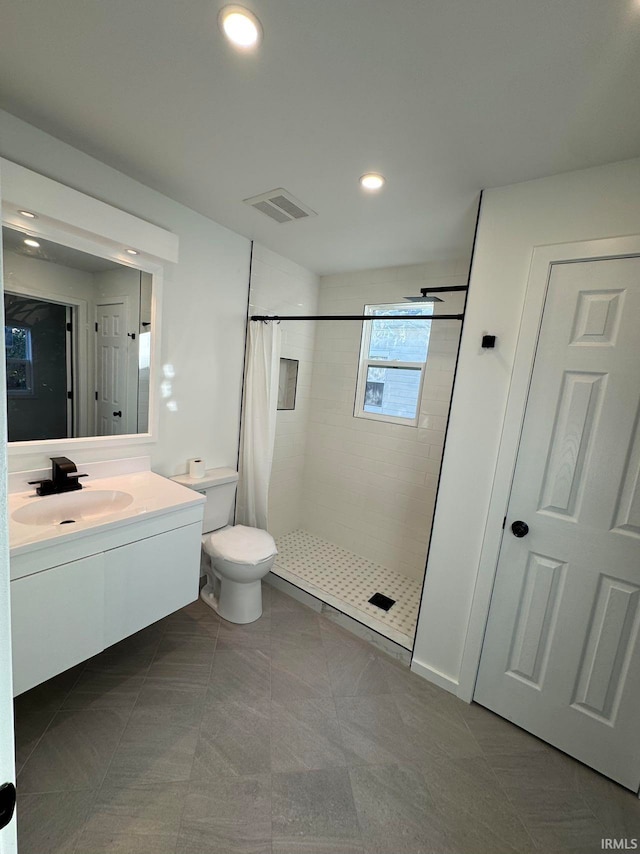 bathroom featuring vanity, toilet, and a shower with shower curtain