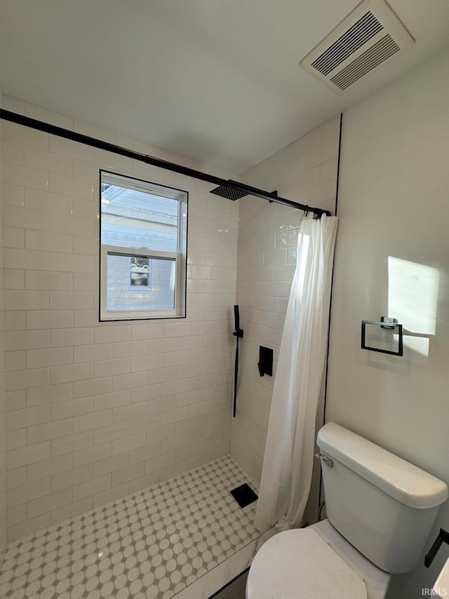 bathroom with toilet and walk in shower