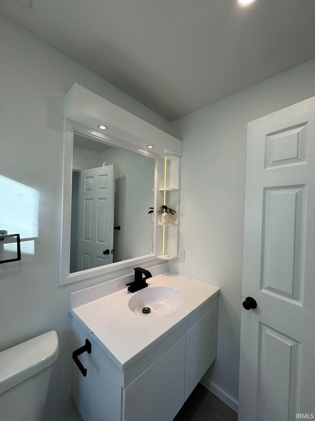 bathroom featuring vanity and toilet