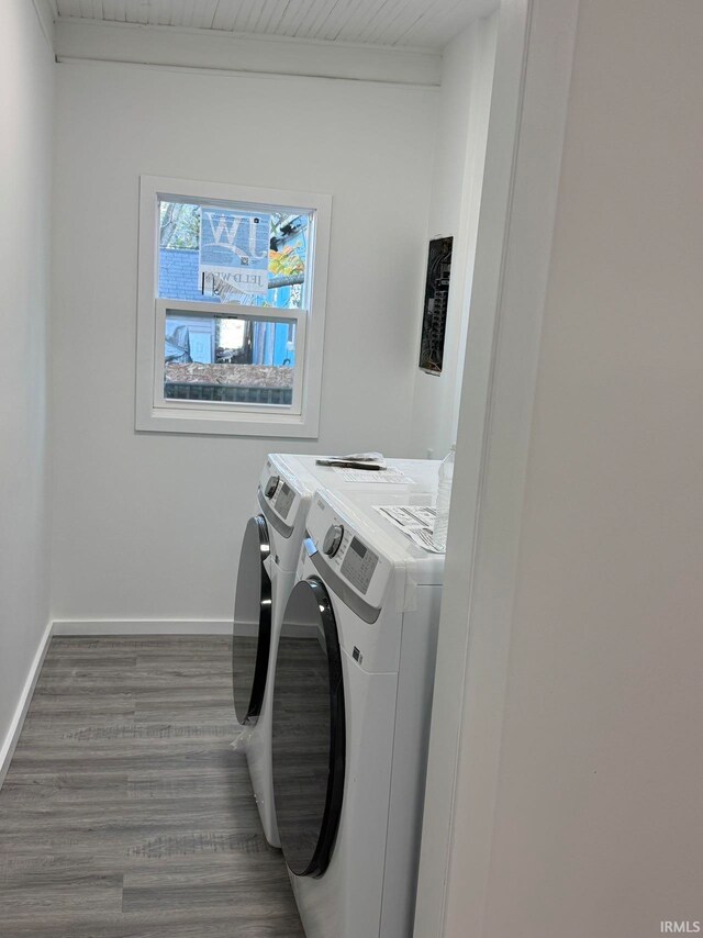 laundry area featuring washing machine and clothes dryer and dark hardwood / wood-style flooring