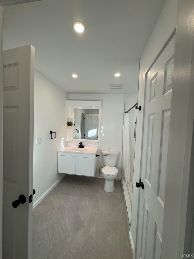 bathroom with vanity, toilet, and a shower with curtain