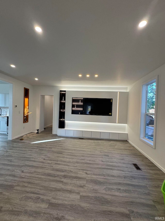 unfurnished living room featuring dark hardwood / wood-style flooring