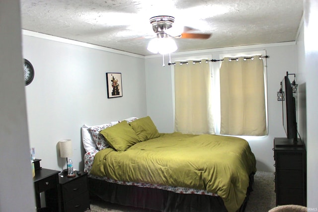 carpeted bedroom featuring ornamental molding, a textured ceiling, and ceiling fan