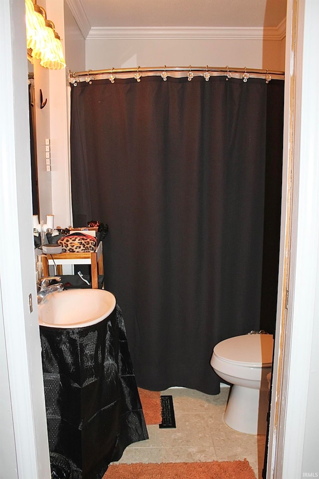 bathroom featuring toilet, crown molding, sink, and tile patterned floors