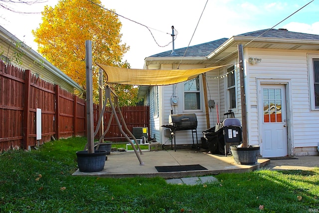 rear view of house featuring a patio area and a lawn