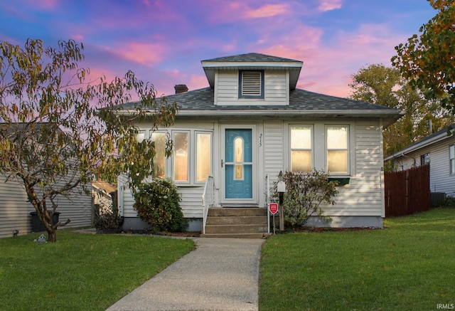 bungalow-style house with a yard