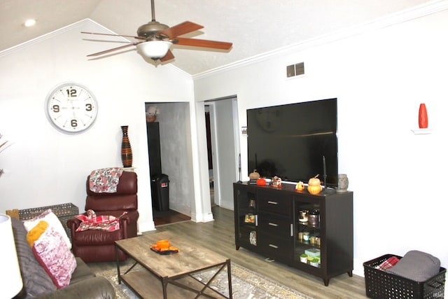 living room with lofted ceiling, ornamental molding, hardwood / wood-style floors, decorative columns, and ceiling fan