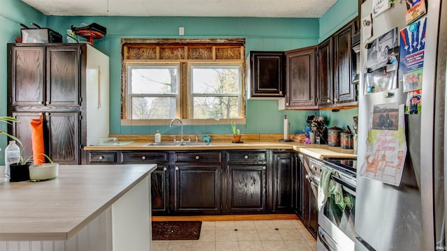 201 S 1st St, Holland, IN 47541 - kitchen with stainless steel appliances, light countertops, and dark brown cabinetry