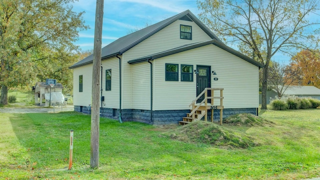 rear view of property with a lawn