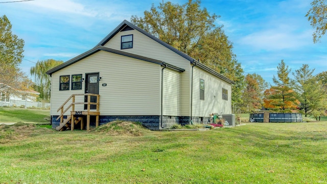 back of house with a yard and cooling unit