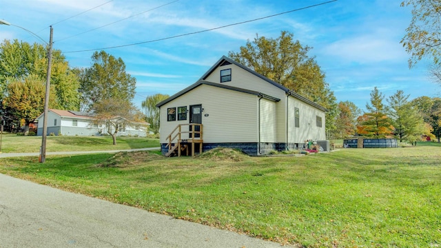 view of side of home with a lawn