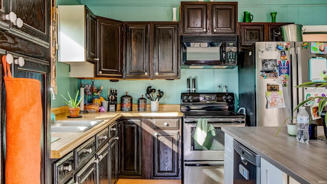 kitchen with sink, appliances with stainless steel finishes, and dark brown cabinetry